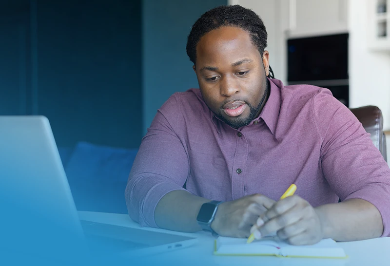 Programs MHFA Male taking notes in front of a laptop participating in Mental Health First Aid Training